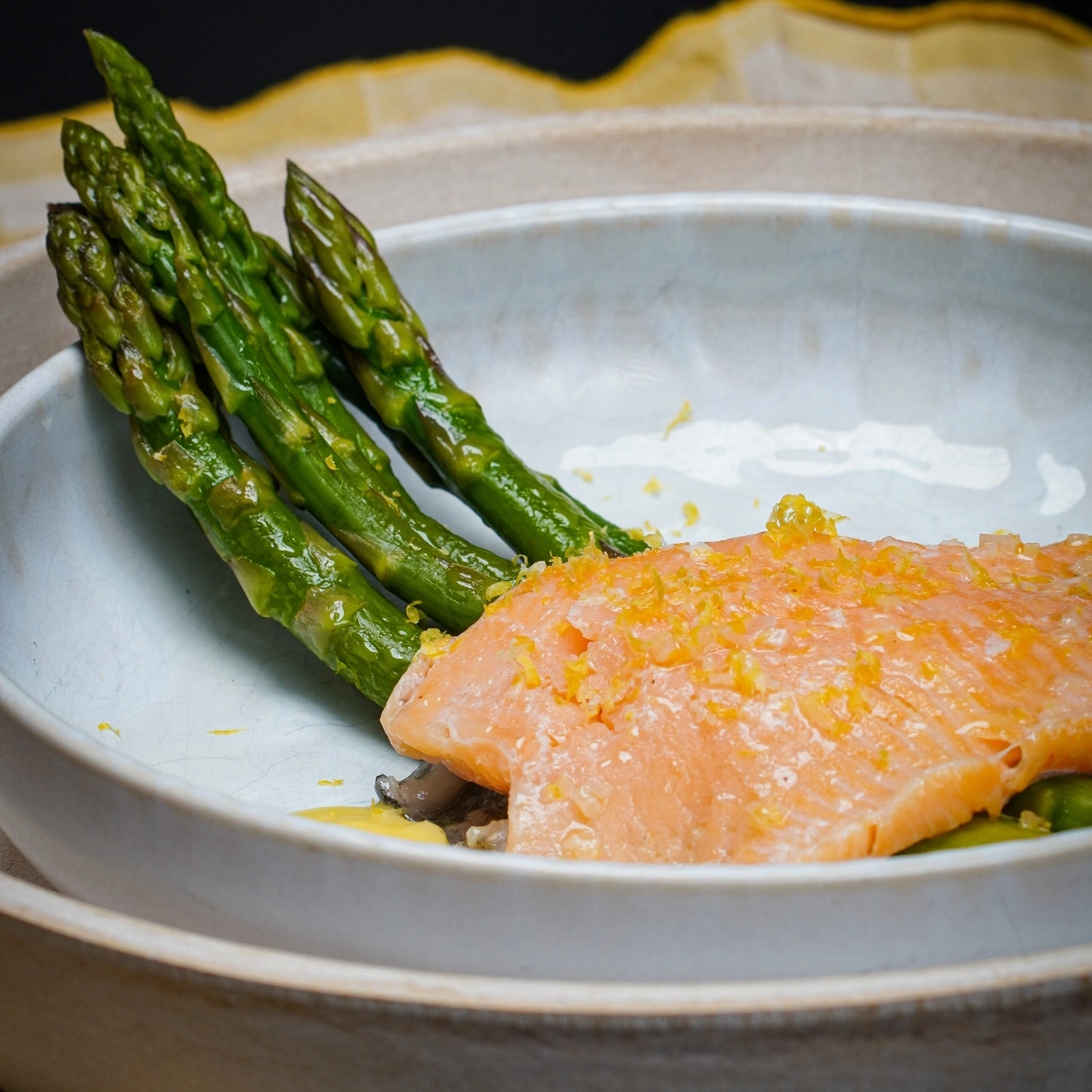 Salmon with asparagus and lemon zest in a bowl