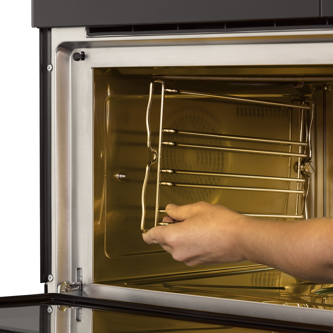 Oven with rack, hand holding rack, interior, golden light, stainless steel