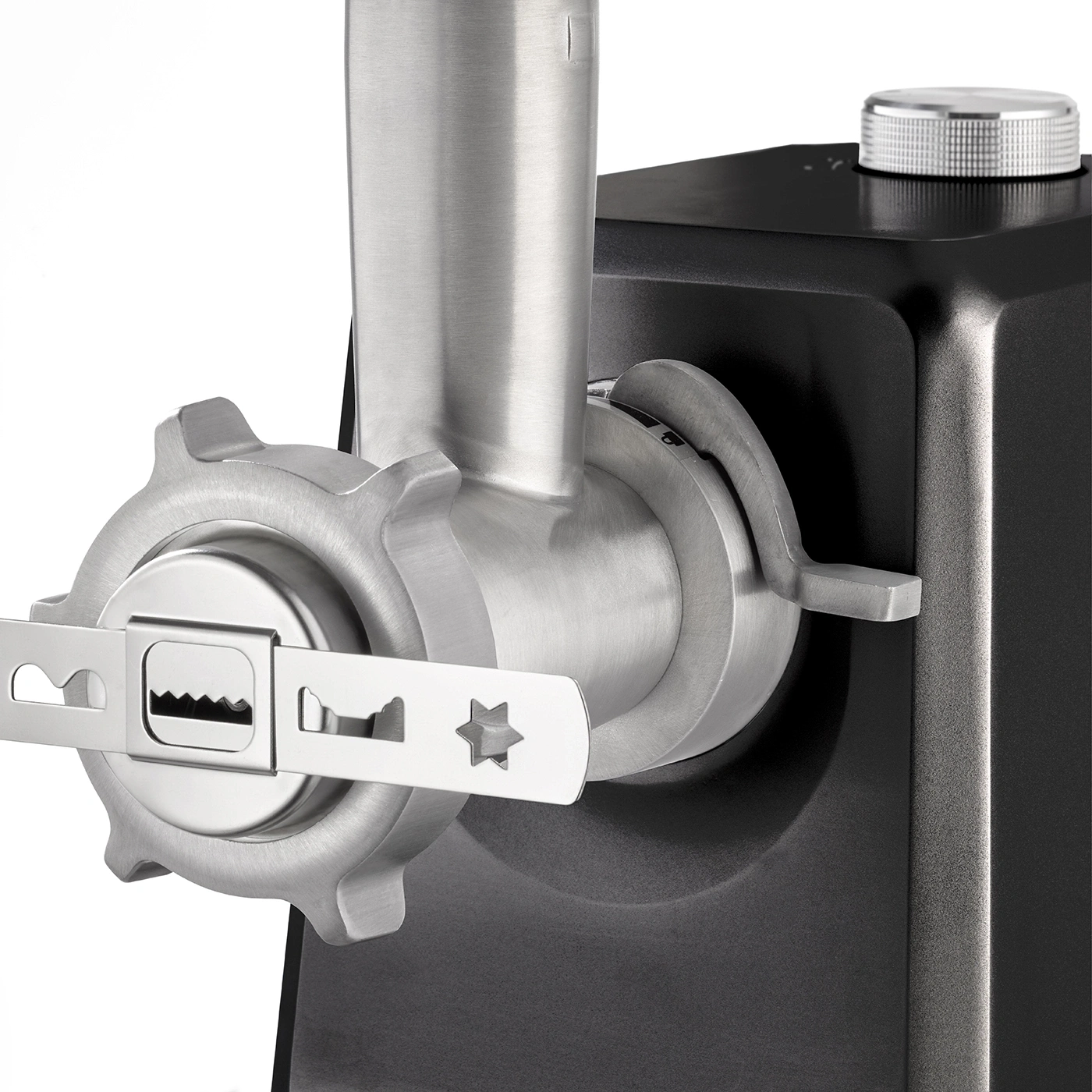Close-up of a meat grinder with metal parts and a black housing.