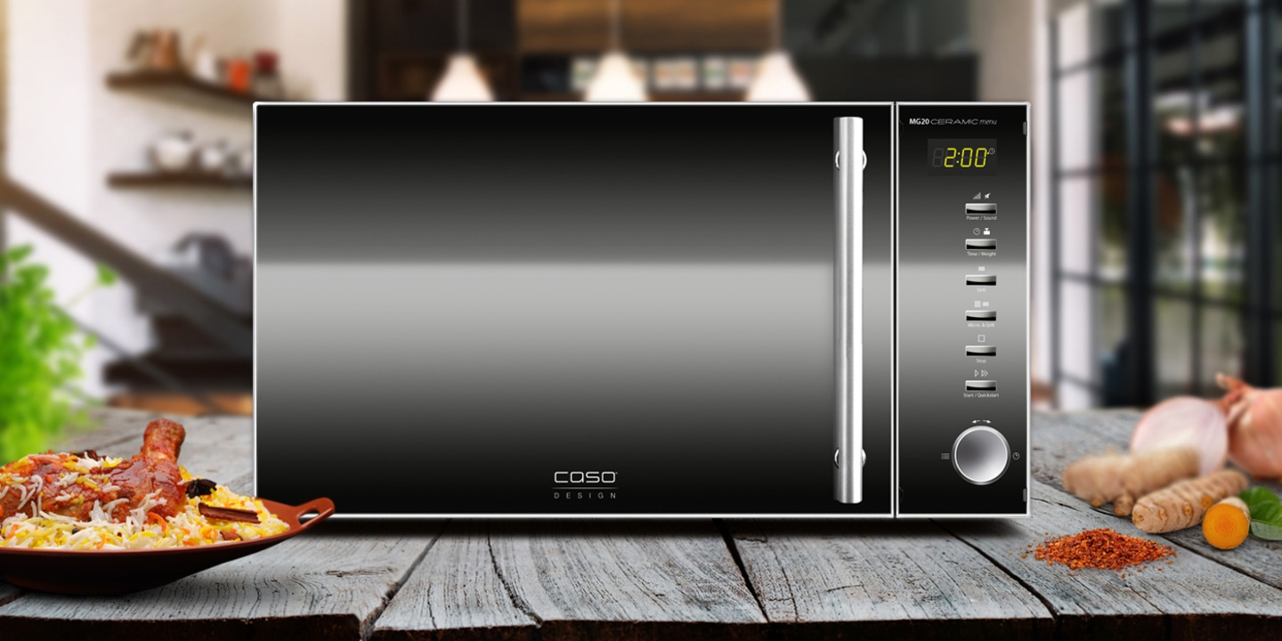 Microwave with food on a wooden table, ready for cooking and eating.