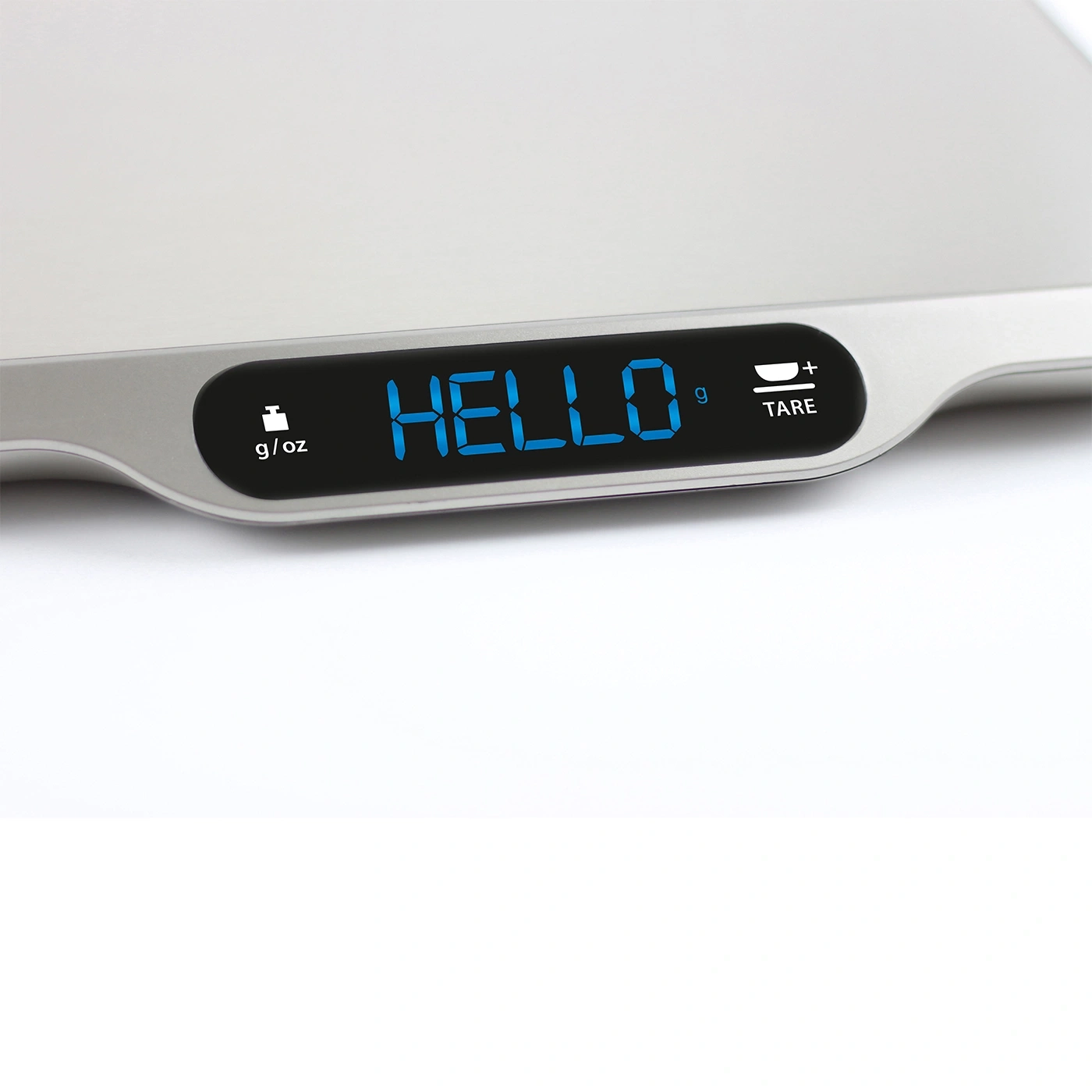 Digital kitchen scale displaying "HELLO" on its screen, close-up shot.