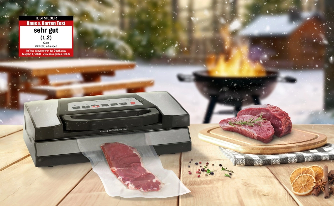 Vakuumierer mit Fleisch und Grill im Schnee