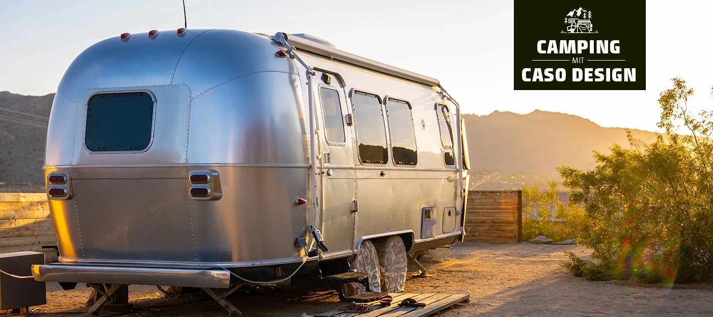 Wohnwagen in der Wüste bei Sonnenuntergang, Camping mit Caso Design