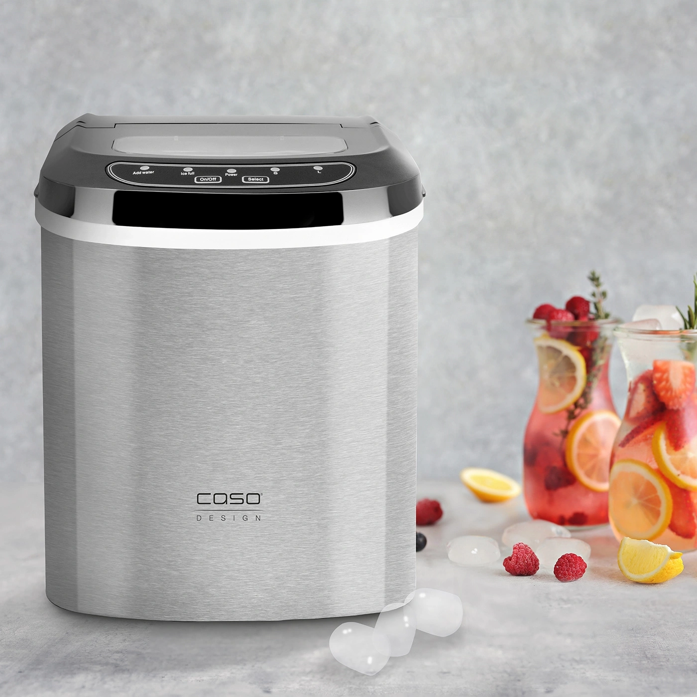 Ice maker with drinks and ice cubes on a table