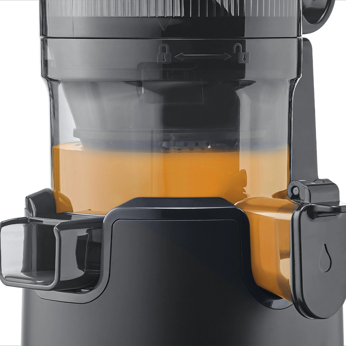 Close-up of a black juicer with juice. Orange juice in the container.