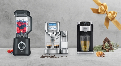 A blender, espresso machine, and coffee maker are placed side by side on a surface.