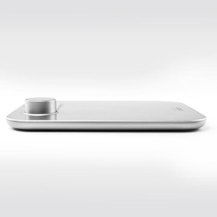 Silver scale with round knob, minimalist design, on a white background, modern and sleek.