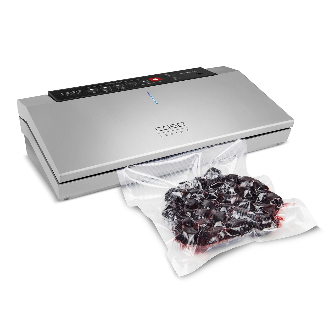 Vacuum sealer with bag filled with dark fruits on a white background.