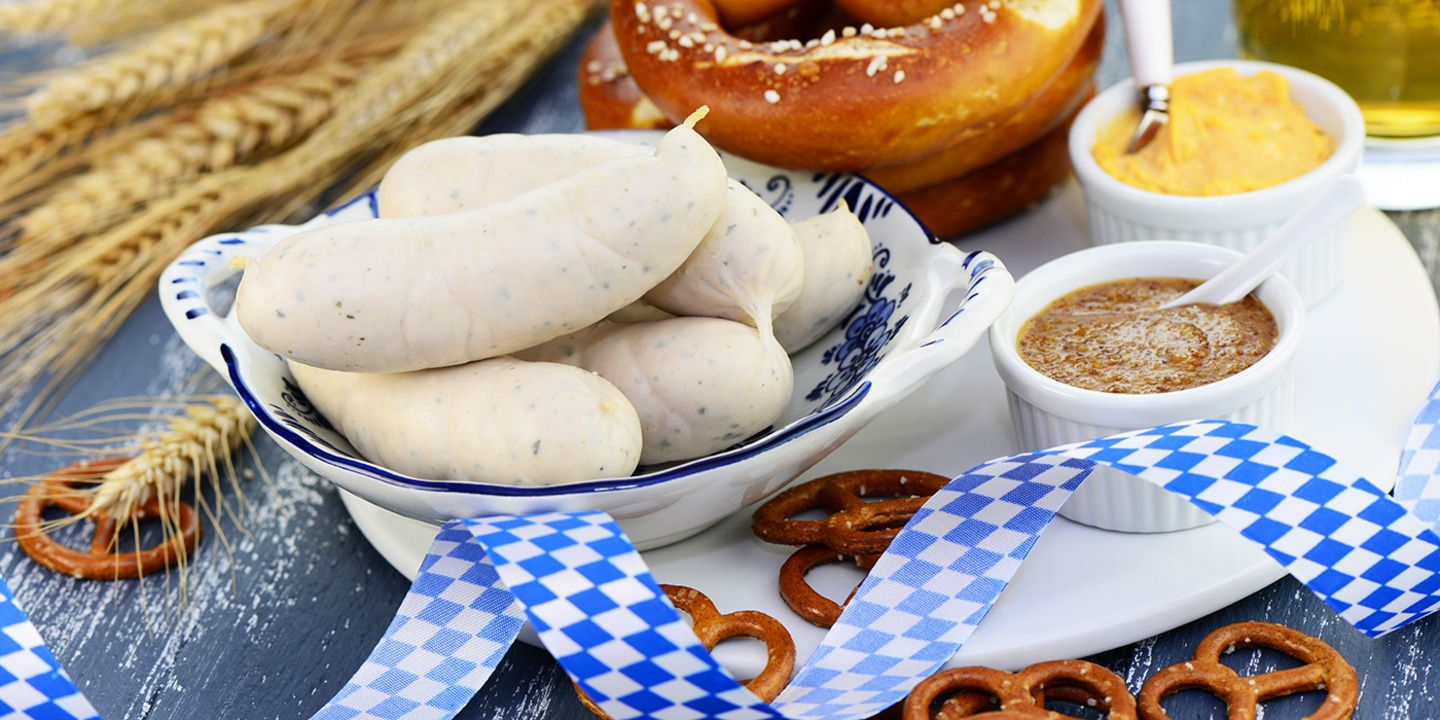 White sausages, pretzels, mustard, blue and white ribbon, Oktoberfest food, close-up