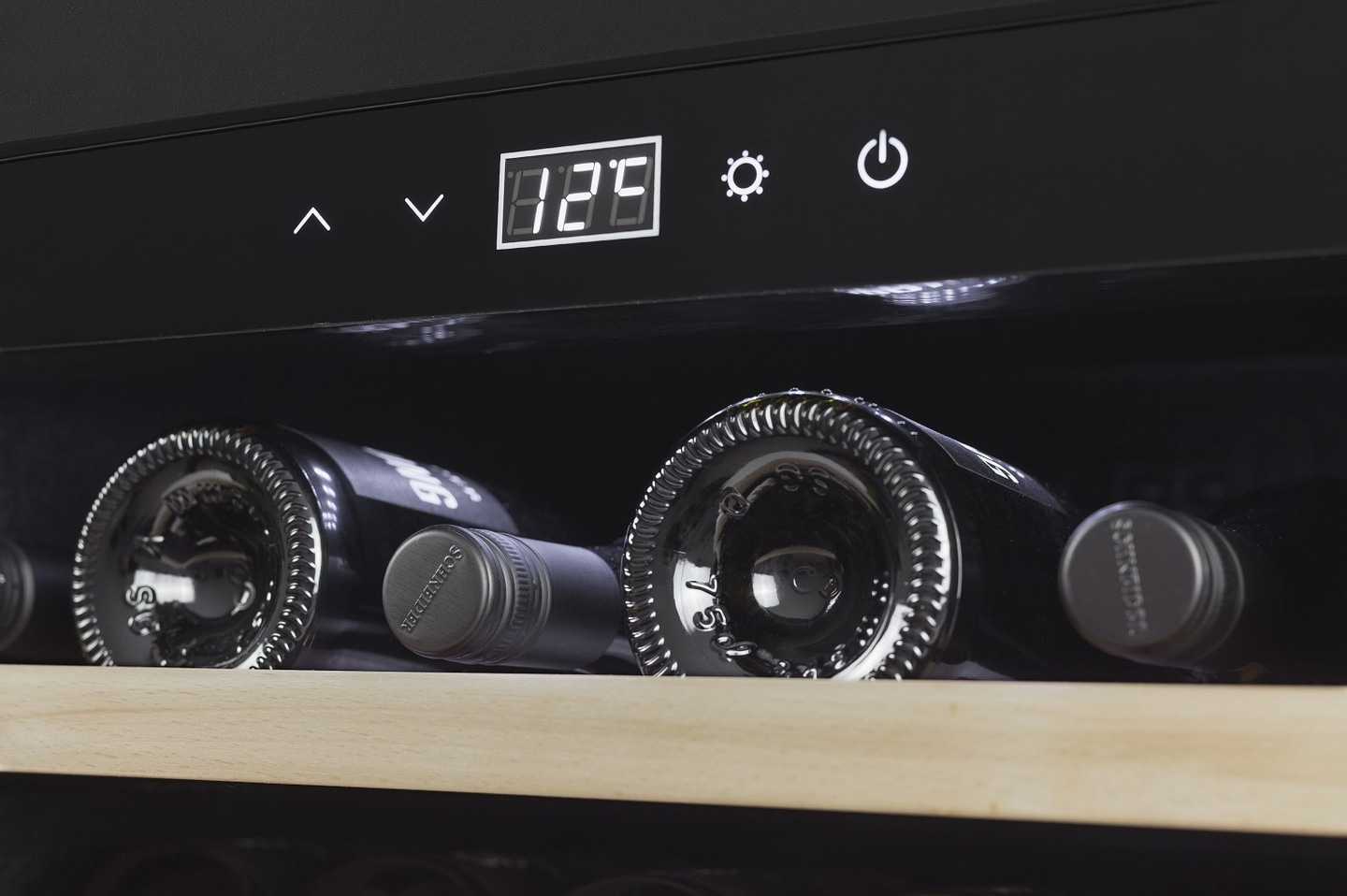 Wine cooler with temperature display and wine bottles inside the fridge.