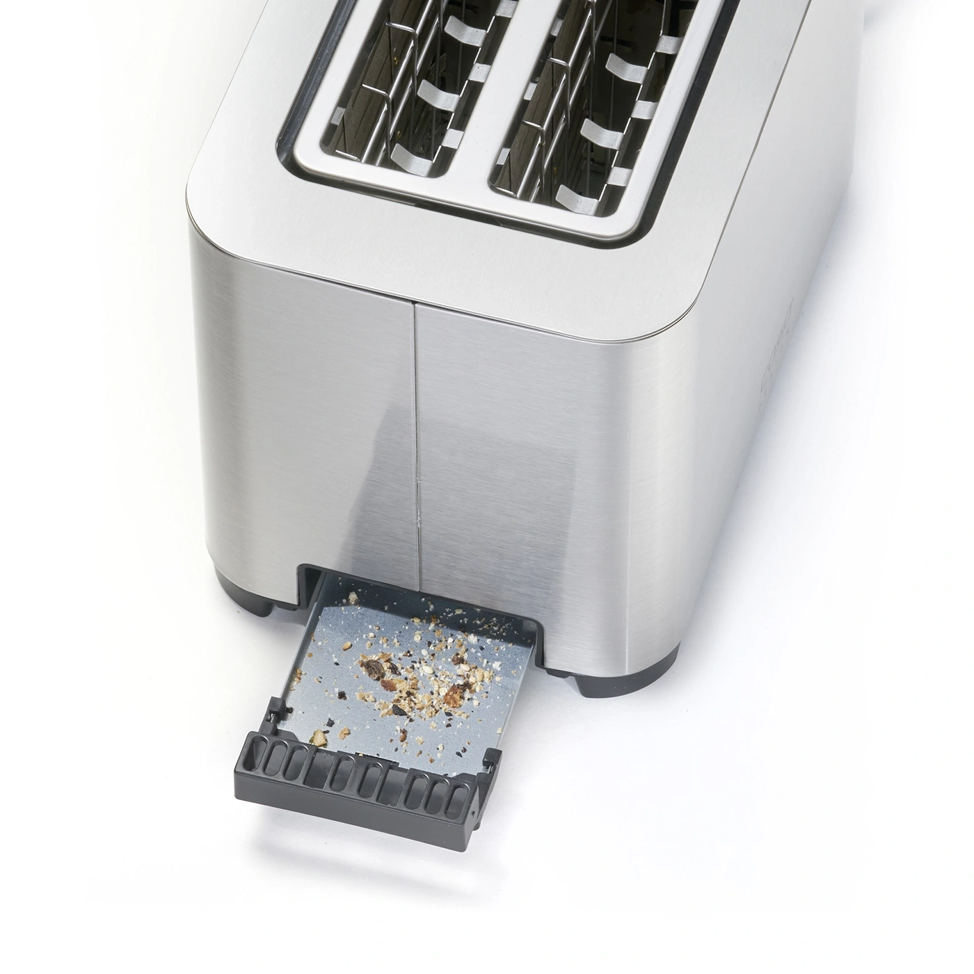 Close-up of a toaster with the crumb tray pulled out and bread crumbs