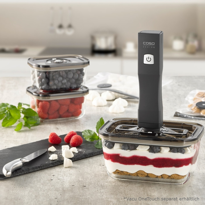 Image of berries, a knife, and a vacuum sealer in a glass container.