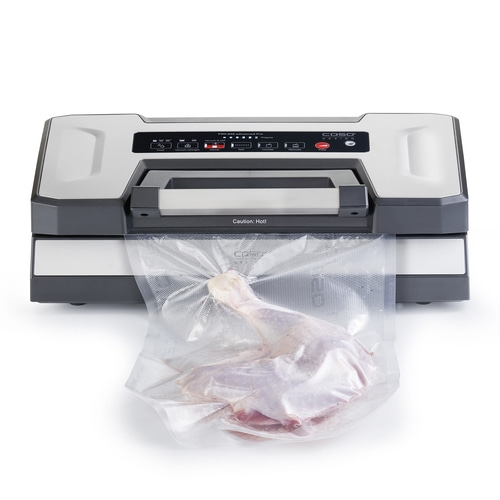 Vacuum sealer with meat in plastic bag, ready for vacuum sealing process.