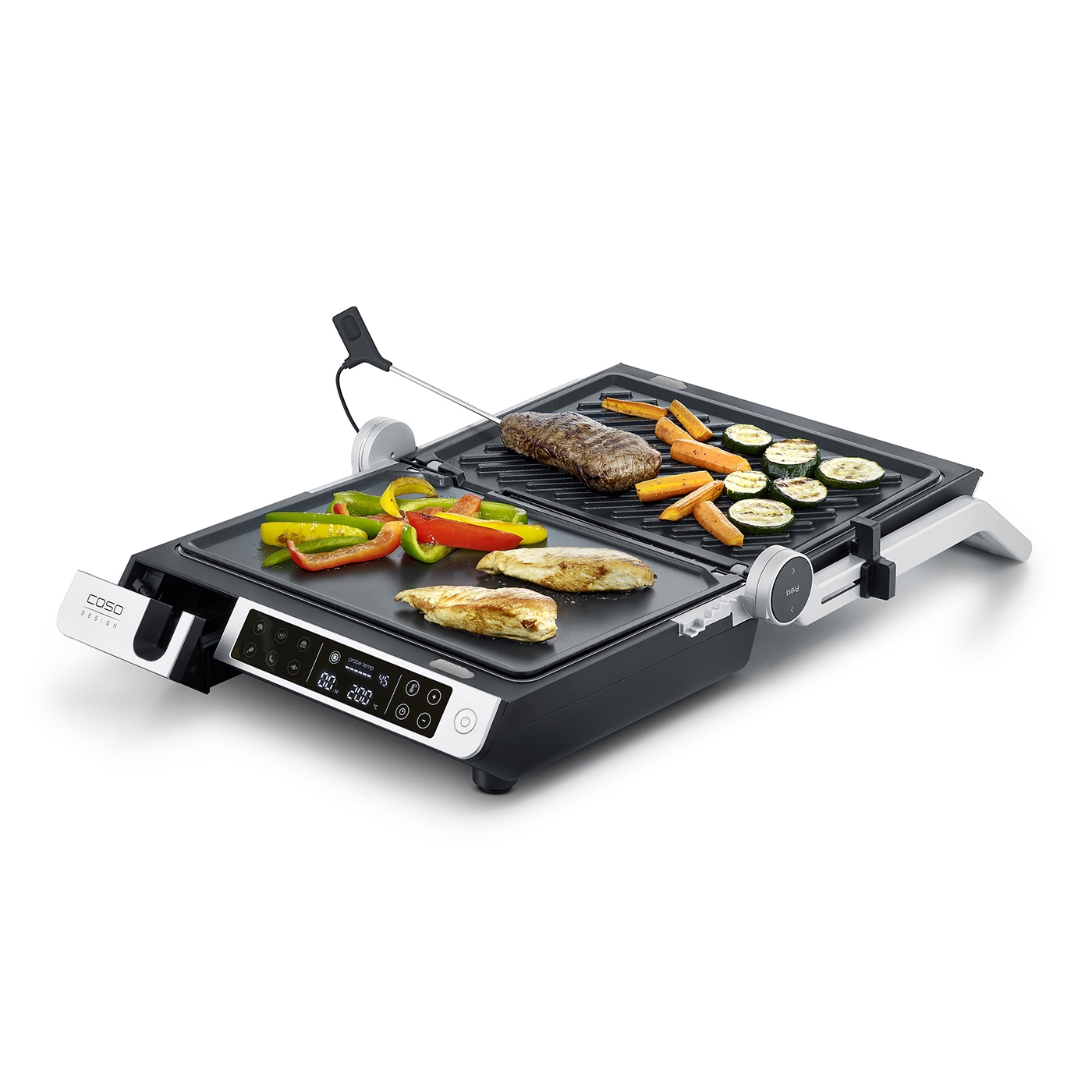 Electric grill with vegetables and meat, ready for cooking.