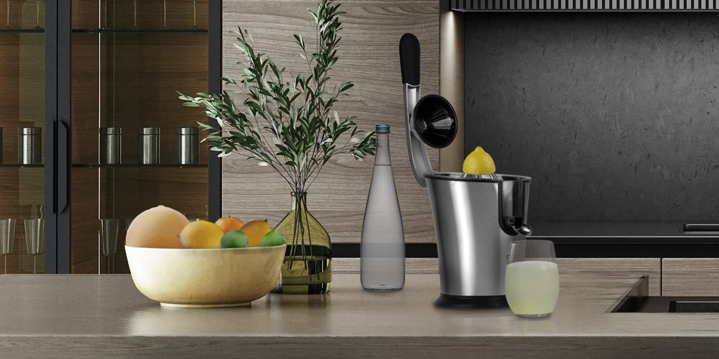 Lemon juicer with lemon and glass, fruits in bowl, kitchen setting