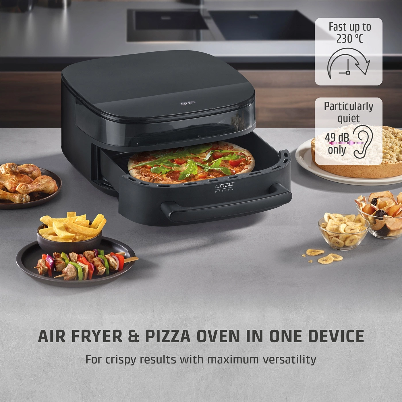 A black air fryer and pizza oven with pizza, chicken, fries, and cake.