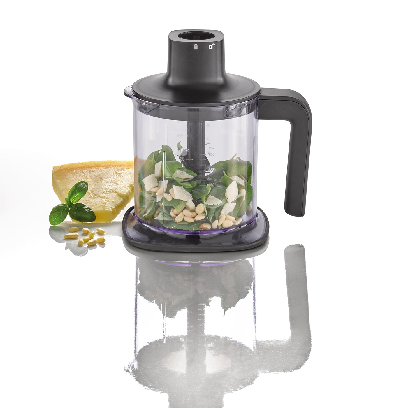 Food processor with pesto ingredients, cheese, pine nuts, basil, spinach