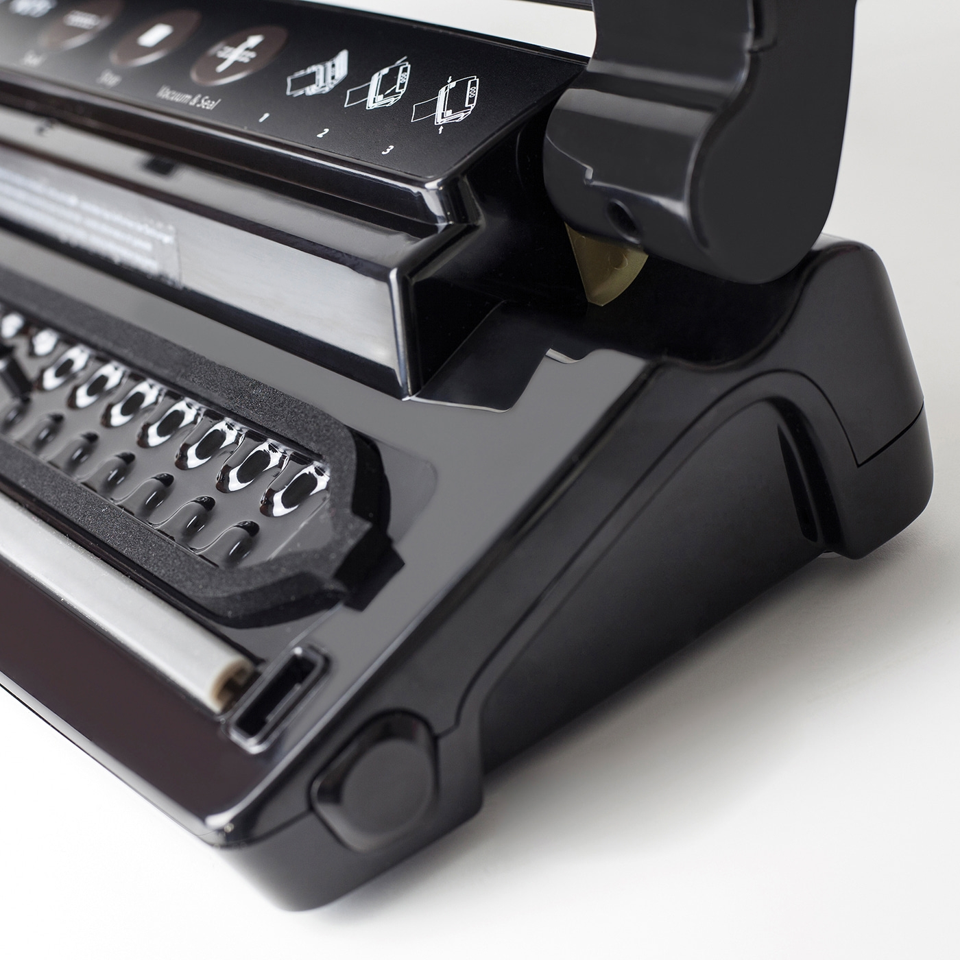 Black vacuum sealer with control panel and vacuum and seal function.