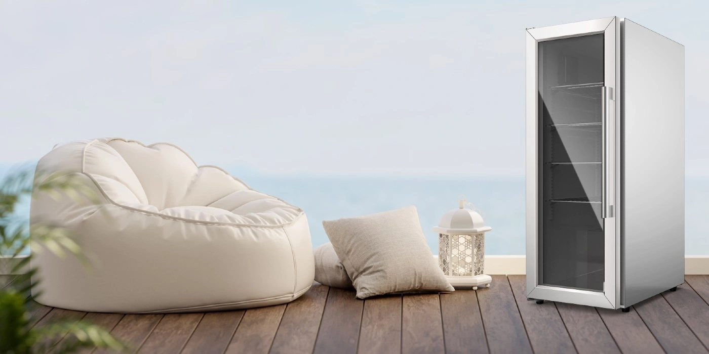 Relaxing scene with fridge, pillows, and beanbag on wooden deck by the sea
