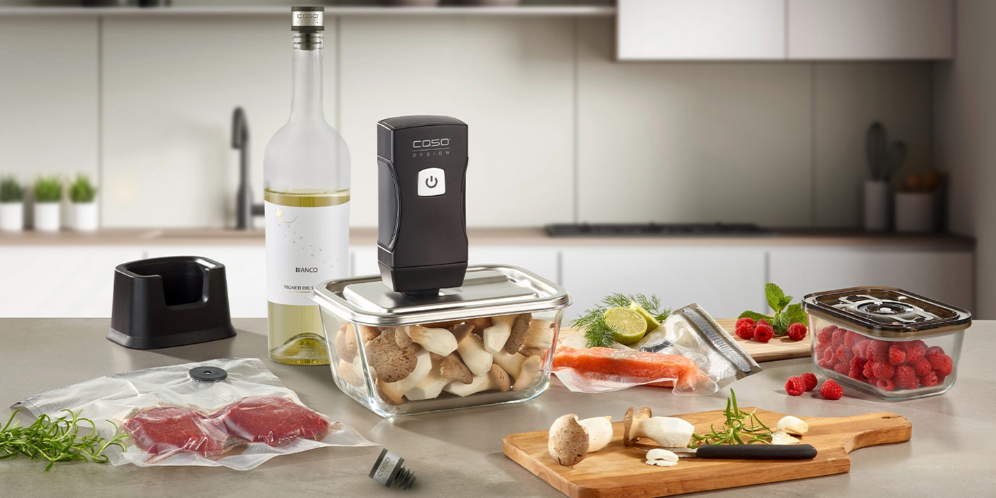 Kitchen scene with vacuum sealer, food items, and wine bottle