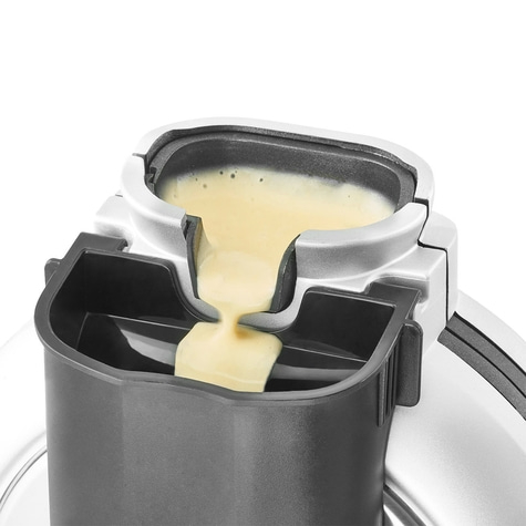 Close-up of a device with yellow liquid pouring into a container, detail shot.