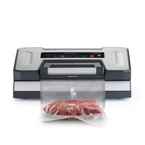 Vacuum sealer with meat in a bag, ready to be sealed for preservation.