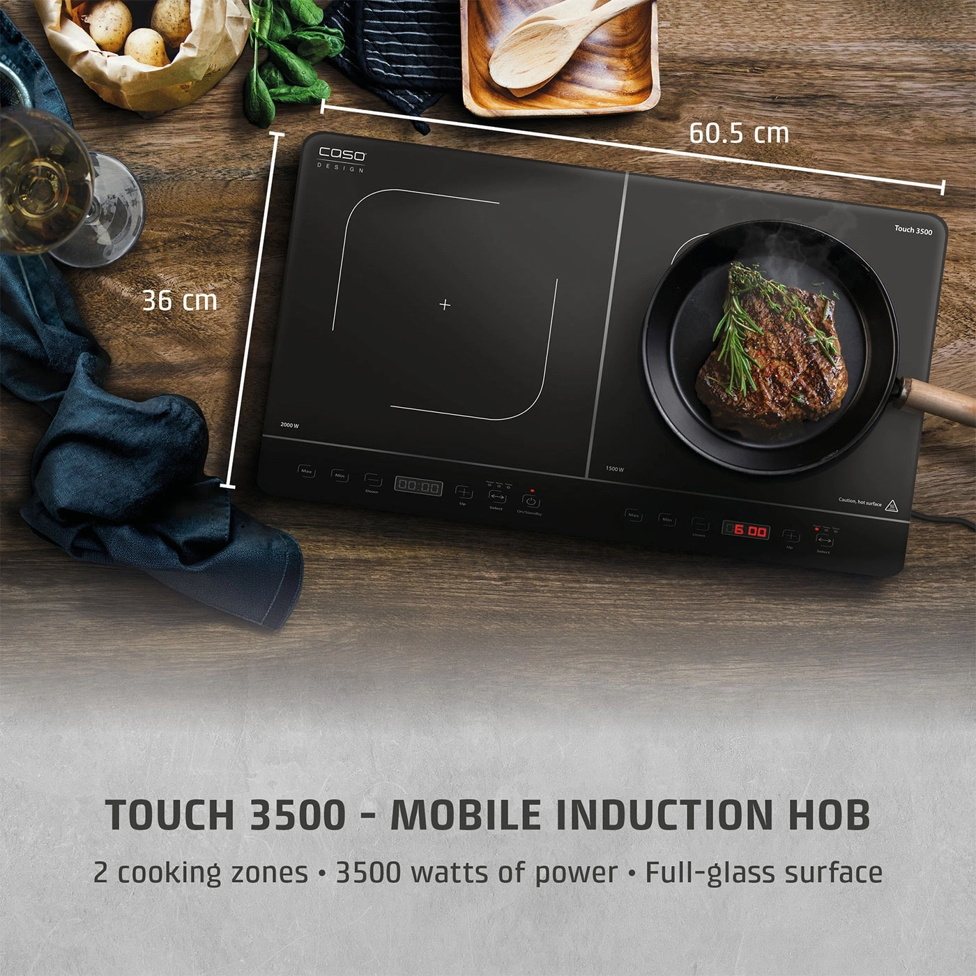 A double zone induction hob with a steak cooking on it.