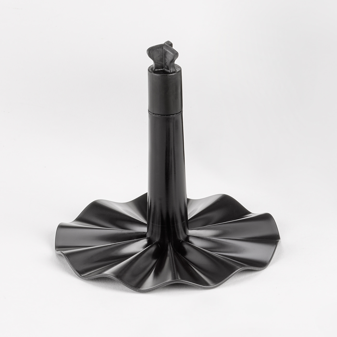 Black stand with a wavy base and a cylindrical middle section, isolated on white.