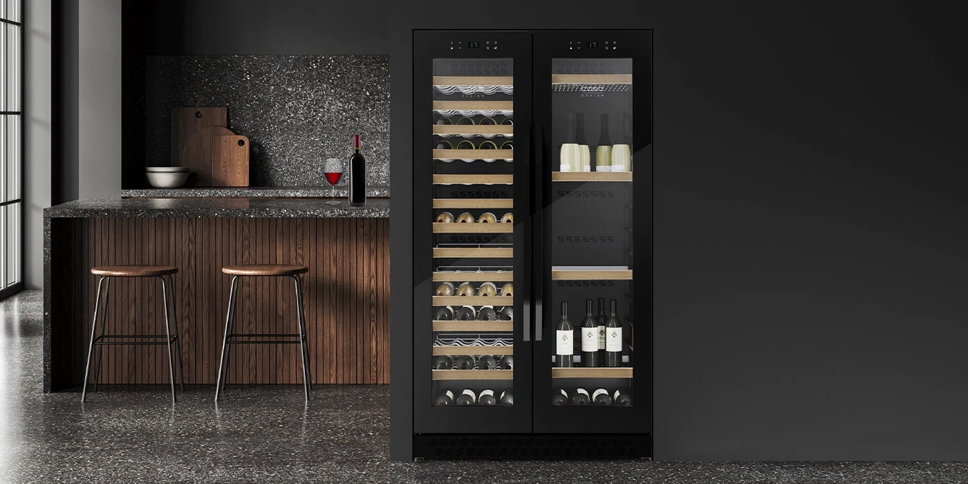 Black wine cooler in modern kitchen with bar stools and wine bottle
