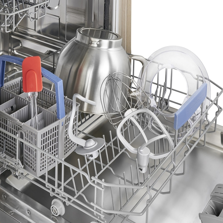 Dishwasher with kitchen utensils: bowl, whisk, spatula, mixing tools, and more.