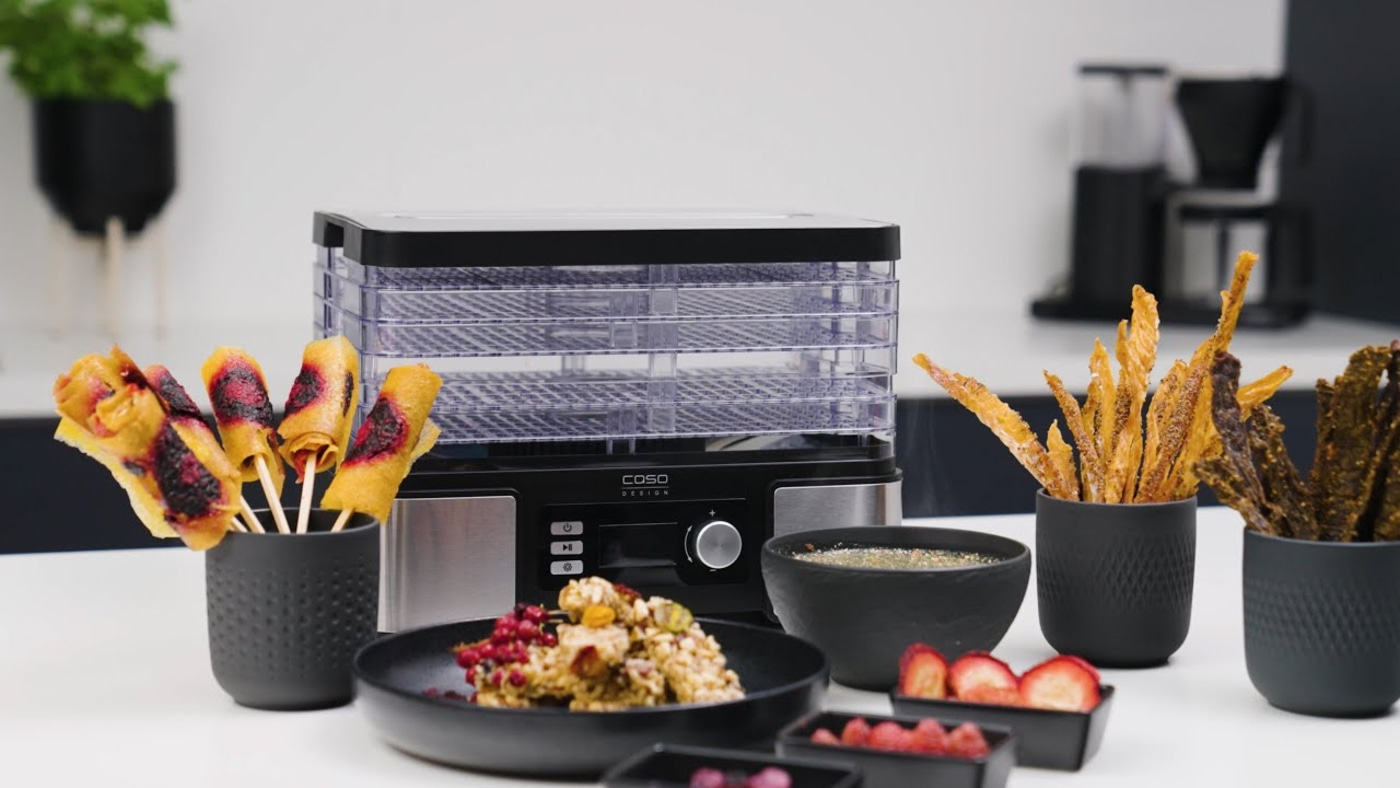 Food dehydrator with snacks and fruits on table, delicious food, healthy eating