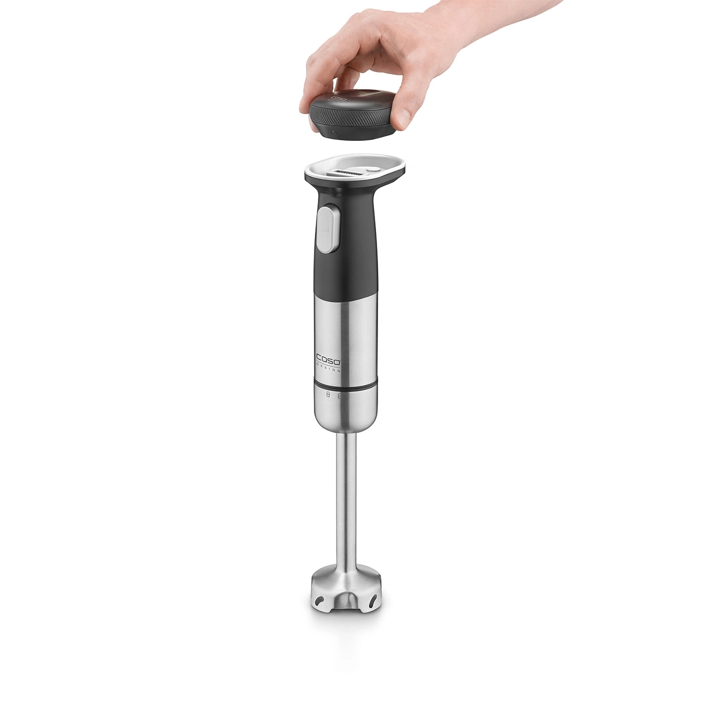 Hand blender with removable lid being held by a hand, product shot.