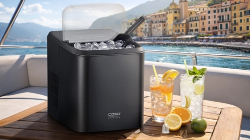 Ice maker on a yacht with drinks and a view of a coastal town.