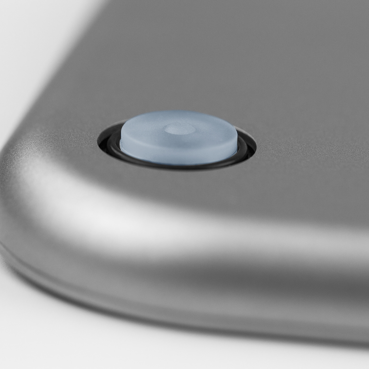 Close-up of a gray scale with a blue button and a black ring around it