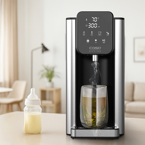A water dispenser with a glass of tea and a baby bottle.