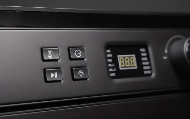 Oven control panel with buttons and digital display for temperature and time.