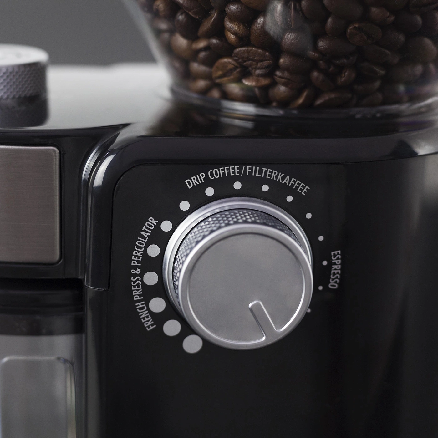 Close-up of a coffee grinder with a dial for different brewing methods, black.