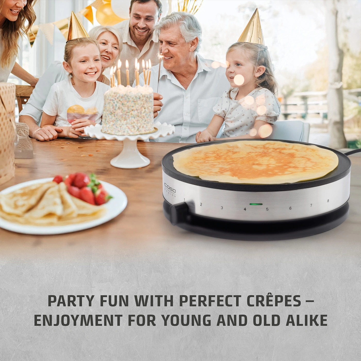 Family celebrates birthday with cake and crepe maker.