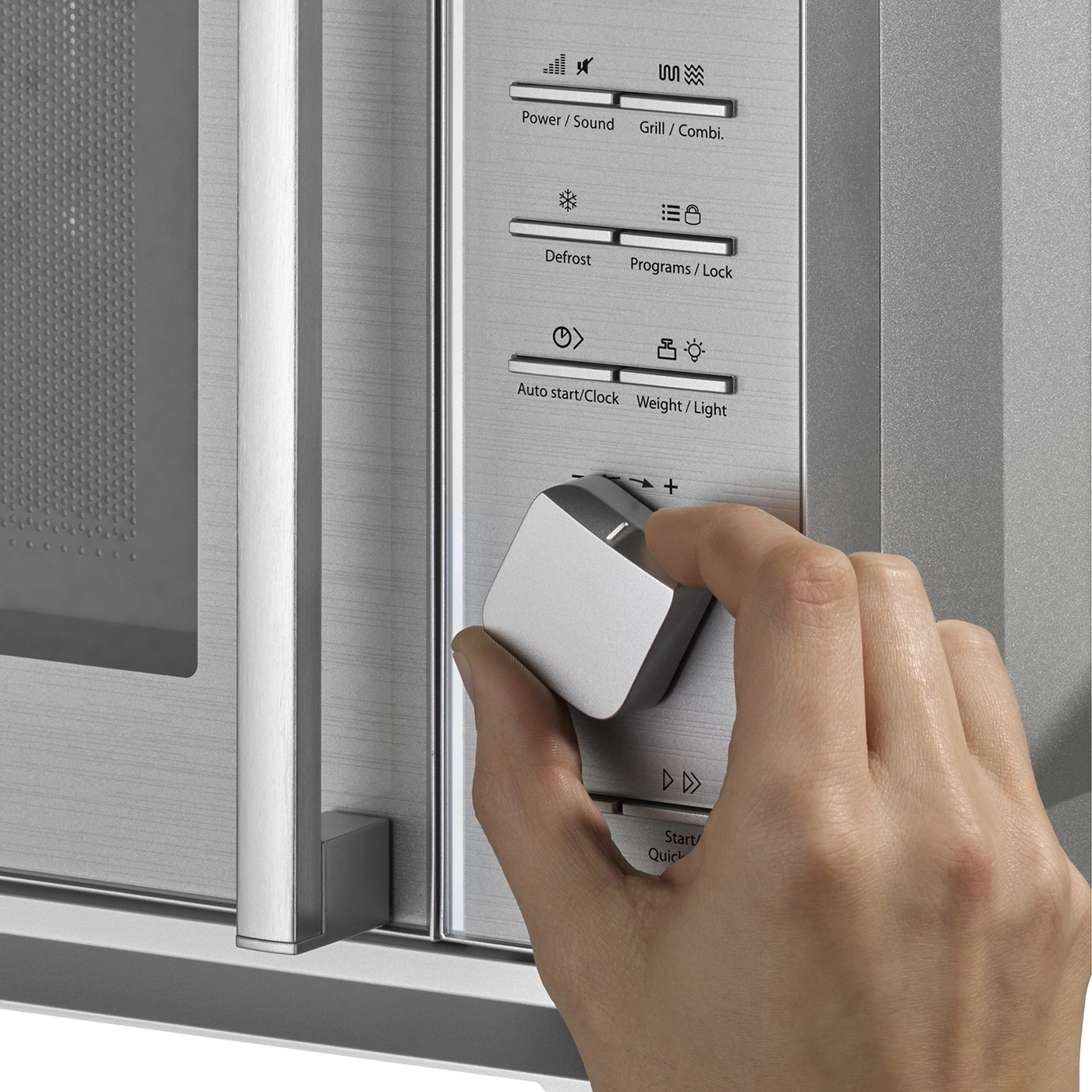 Microwave with controls, dial and hand to change settings, power, defrost, start.