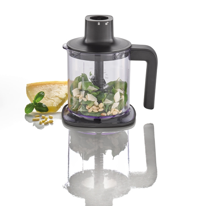 Food processor with pesto ingredients, cheese, pine nuts, basil, spinach
