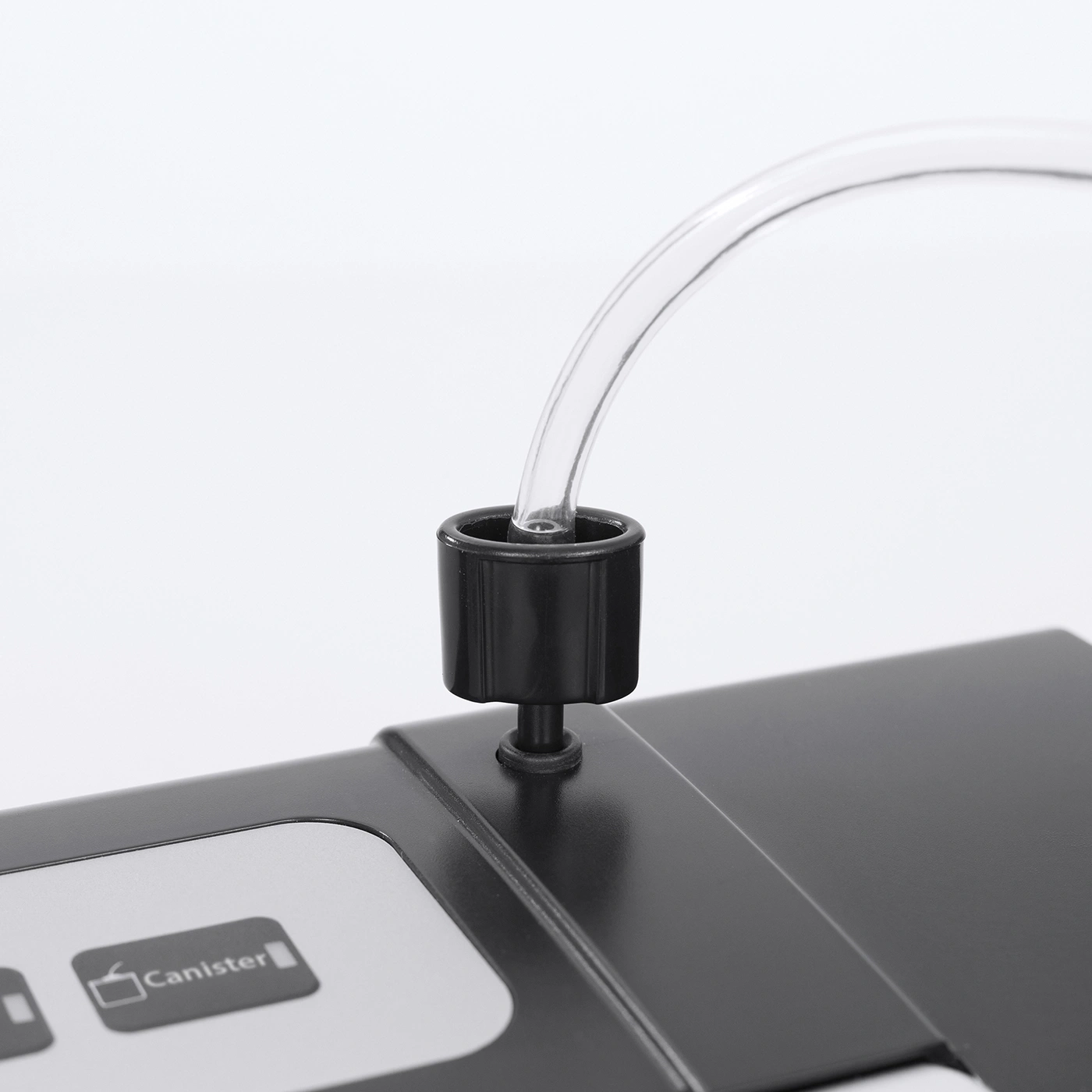 Close-up of a black device with a tube and the word 'Canister' on it.