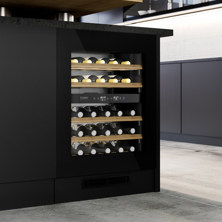 Black wine cooler in modern kitchen with wine bottles and temperature display.
