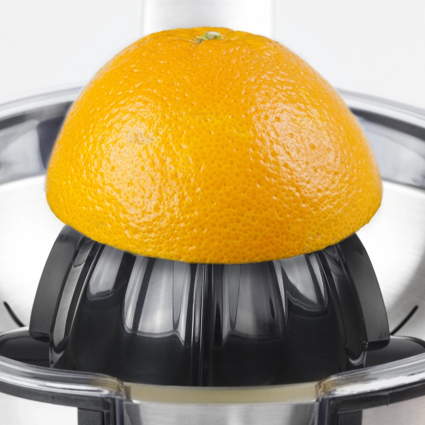 Close-up of an orange on a citrus juicer, ready to make juice.