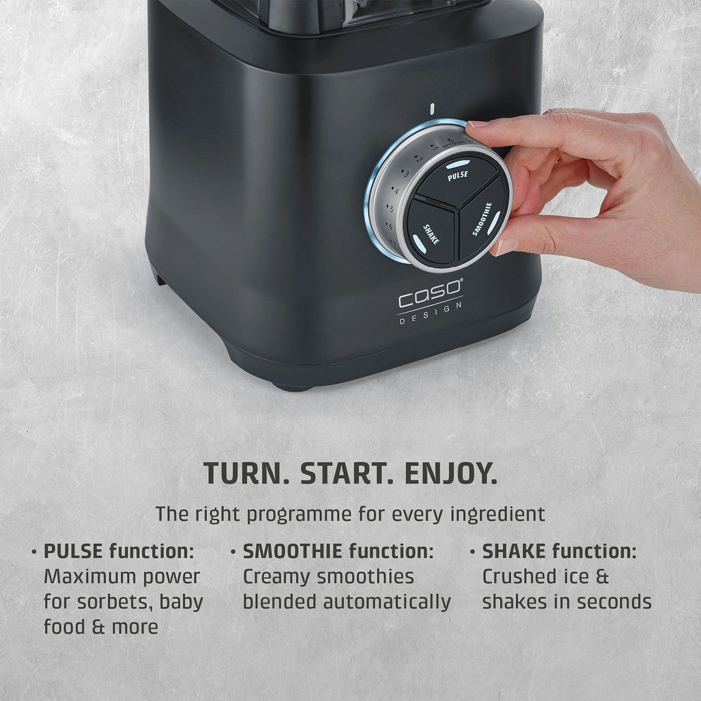 A black blender with a hand turning the dial to select a program.