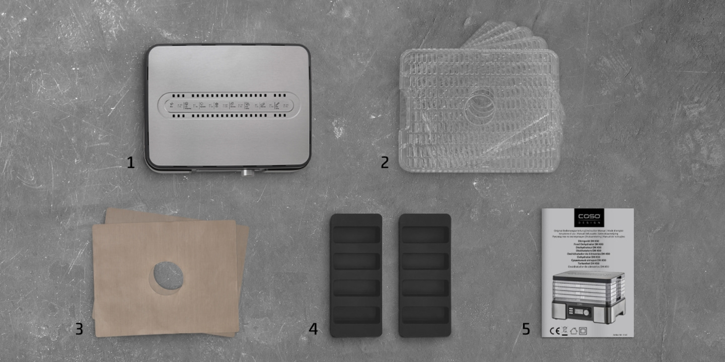 Food dehydrator with accessories: trays, paper, holders, and instruction manual.