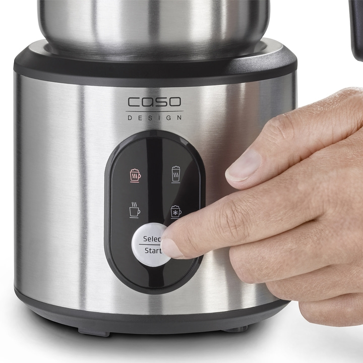 Close-up of a milk frother with control panel and hand pressing a button to start.
