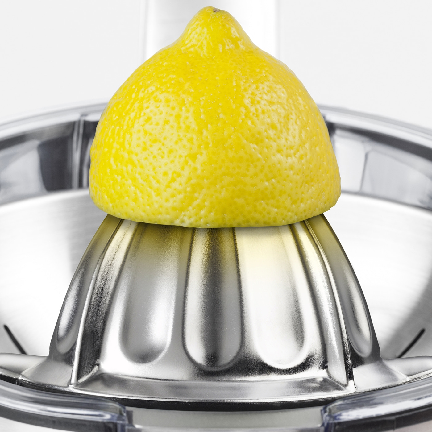 Lemon on a lemon squeezer, close-up, yellow, stainless steel, kitchen, juice