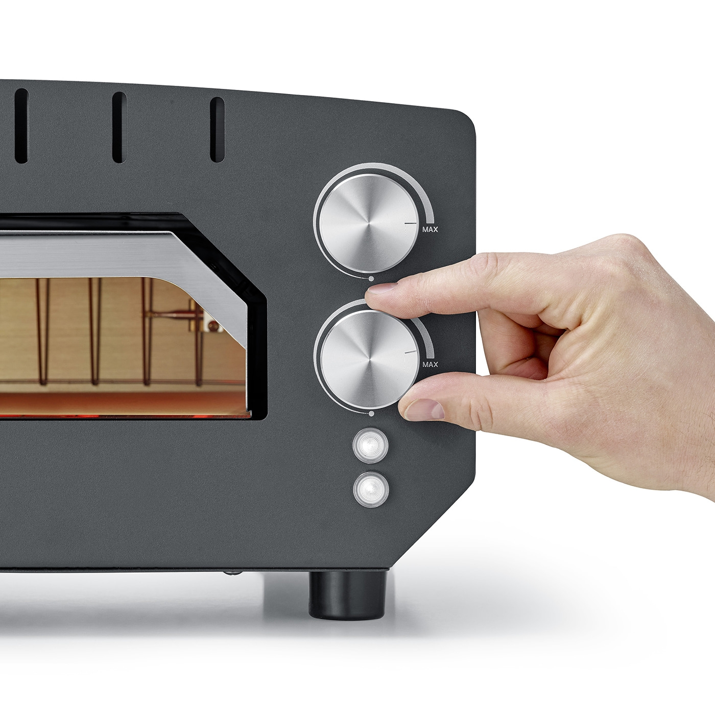 Oven with knobs, hand turning knob to max, close-up, grey appliance