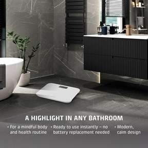 A white bathroom scale in a modern bathroom setting.