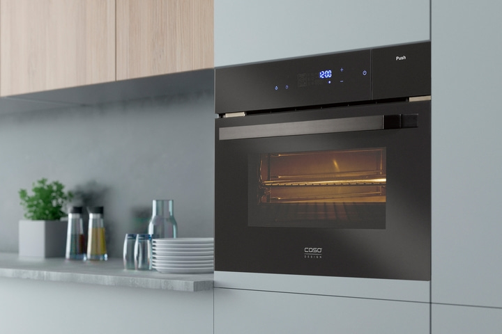 Black oven in kitchen with clock and logo, modern design and style